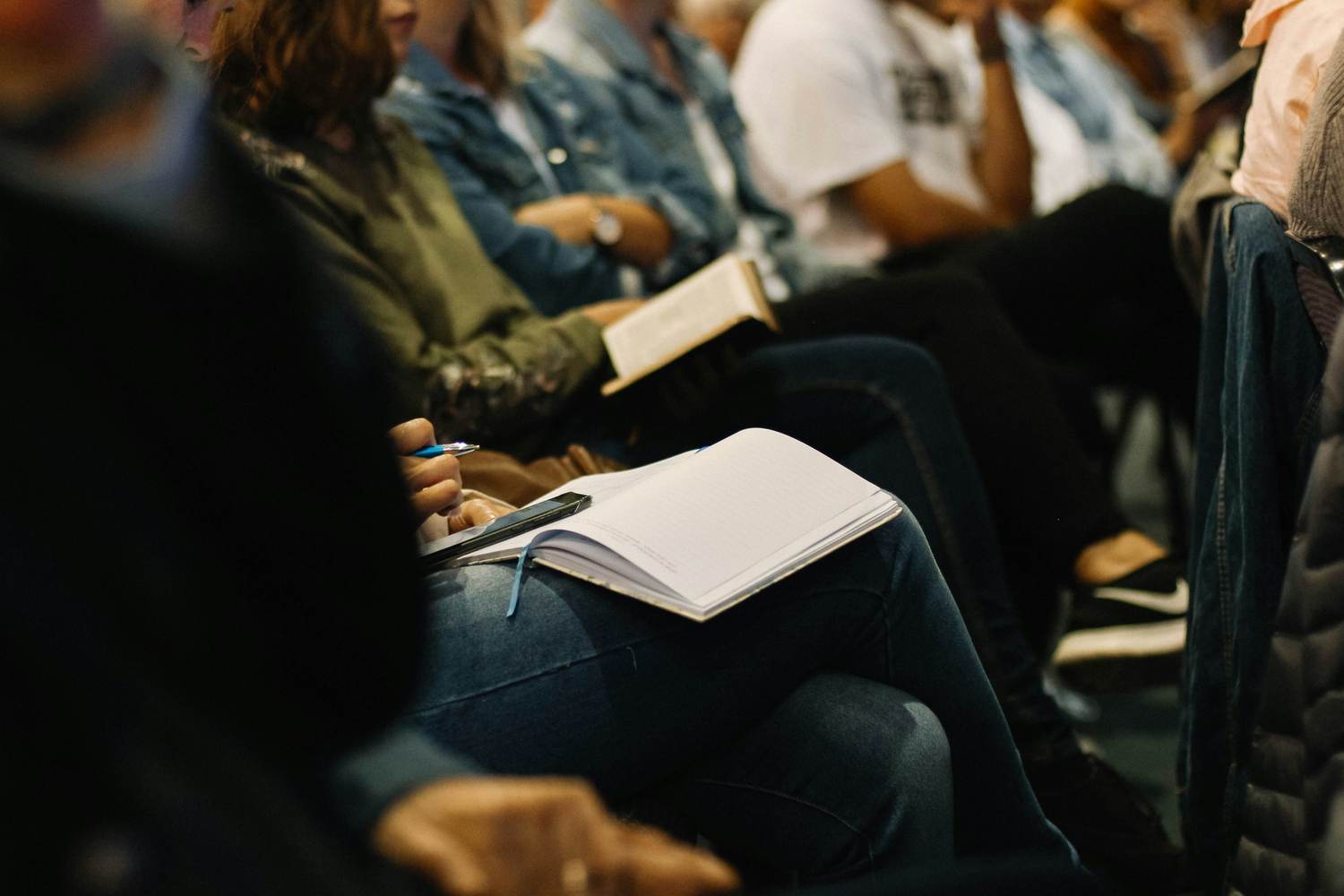 Participants taking notes during a professional workshop